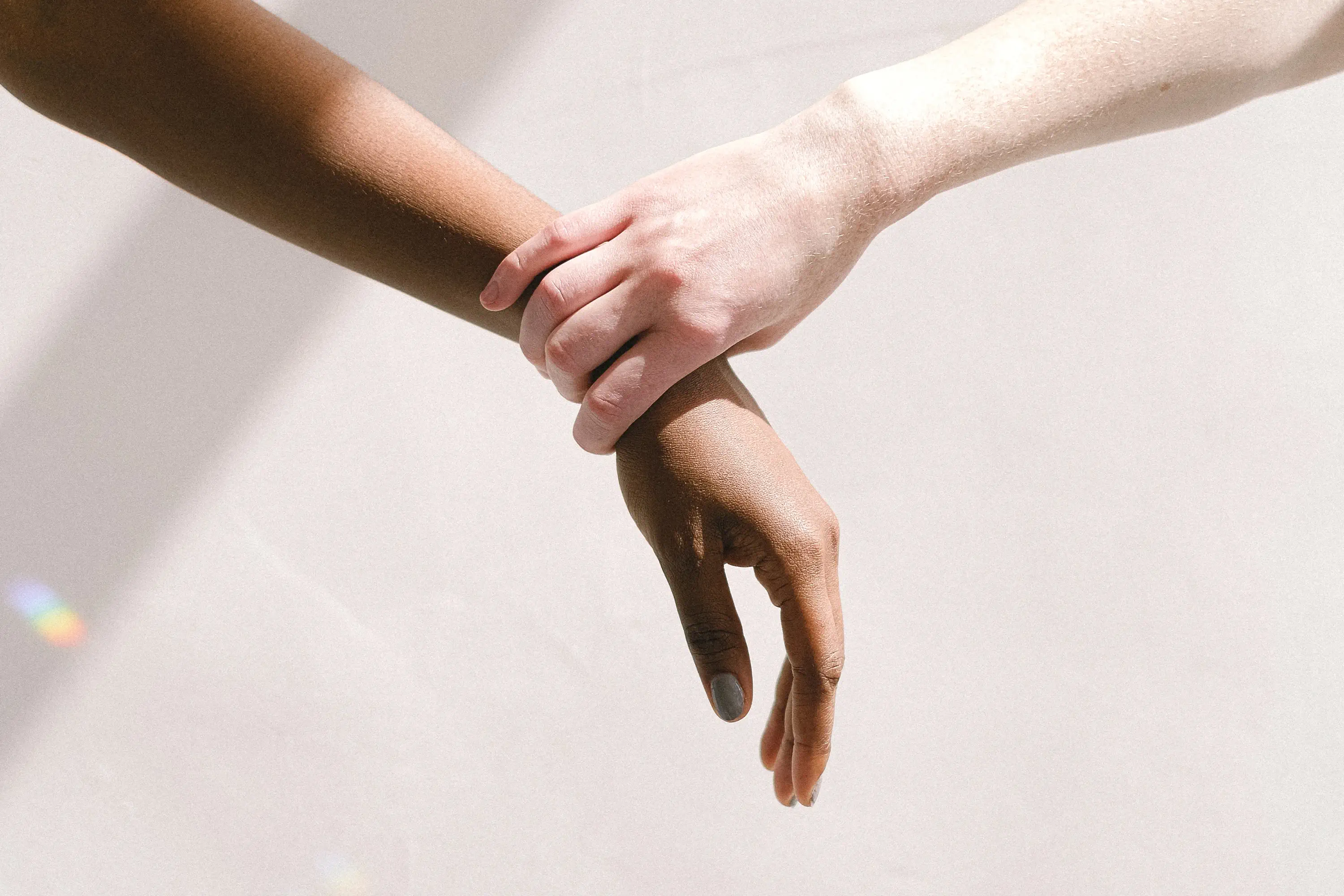 hand holding another person's wrist